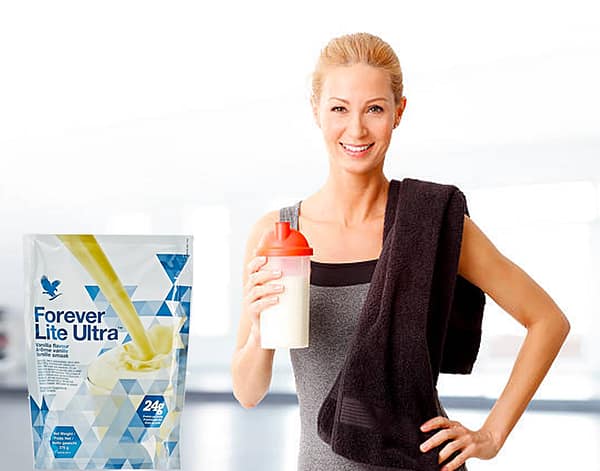 Health fit woman drinking Forever Living Products Ultra Lite Vanilla plant based protein shake